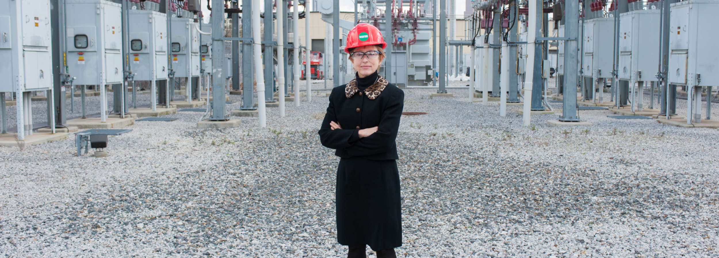 Women standing in front of power plant