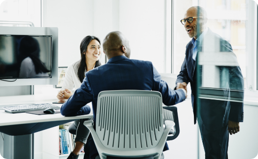 Three coworkers in an office space.