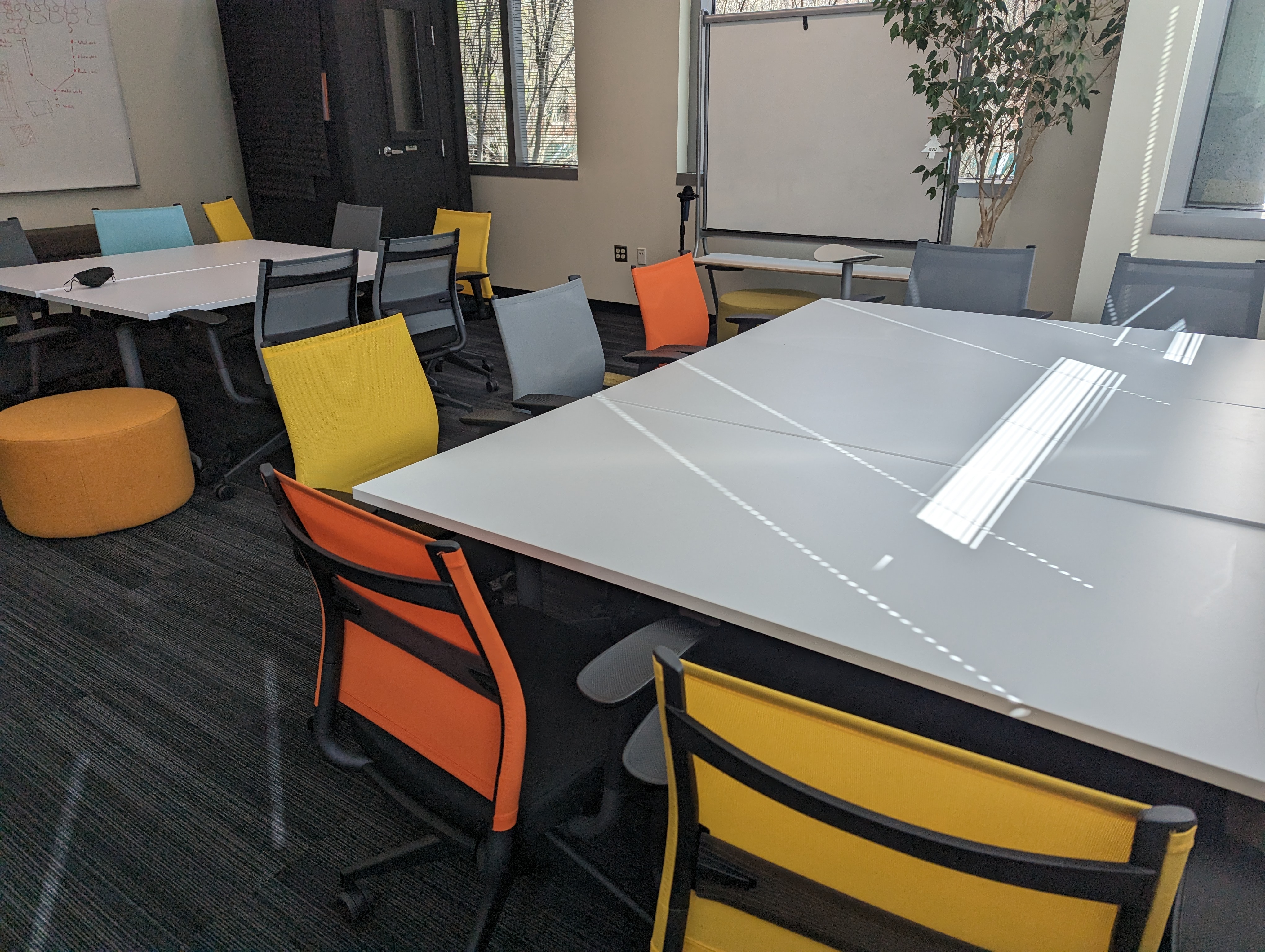 two tables with colorful chairs