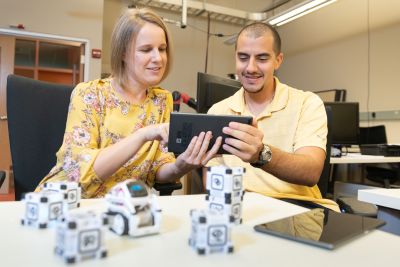 Faculty & Student discussing shape shifting robots