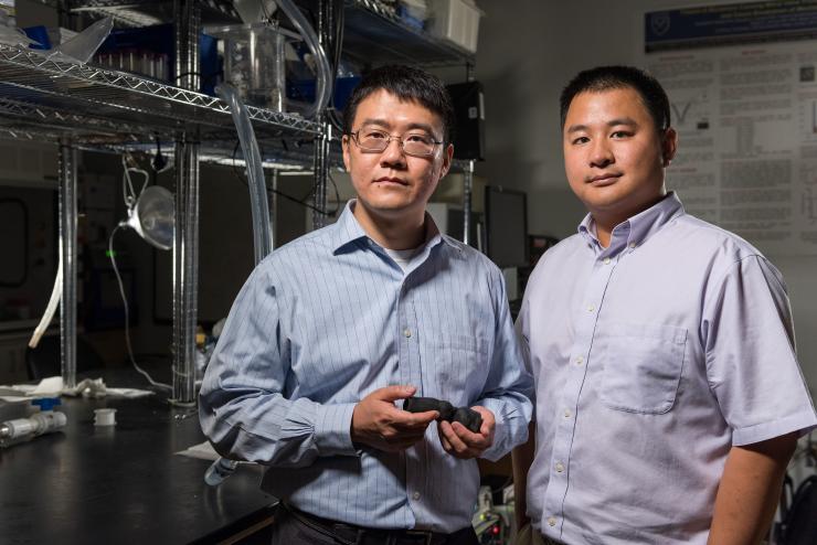 <p>Zhen Qian, chief of Cardiovascular Imaging Research at Piedmont Heart Institute, and Kan Wang, a researcher at Georgia Tech, are pictured at the Structural Heart Research &amp; Innovation Laboratory, part of Emory University's Carlyle Fraser Heart Center within the Division of Cardiothoracic Surgery, where flow testing was performed with the 3-D printed heart valve models.  (Credit: Rob Felt)</p>