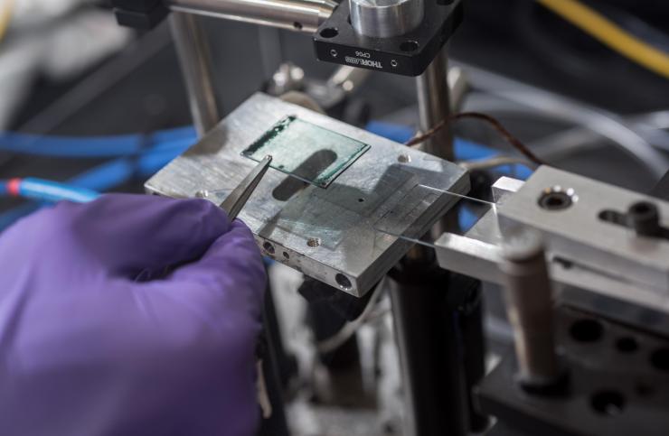 <p>Electronic polymer film on glass after blade coating from an aqueous ink. The blade coater shown is a small scale instrument that prints through shear force, mimicking large scale industrial roll-to-roll coating. Credit: Georgia Tech / Rob Felt</p>