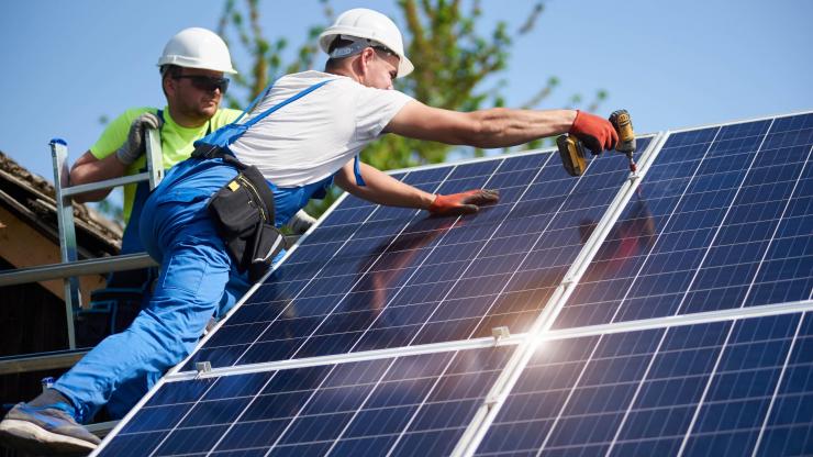 Workers installing solar panels.