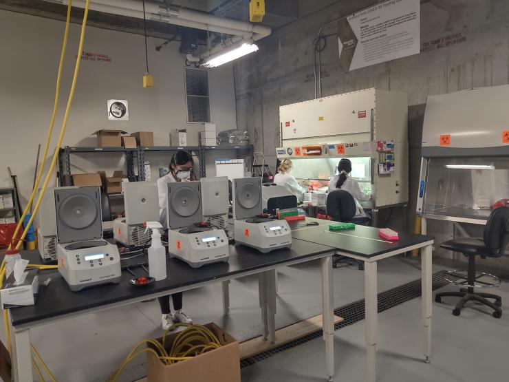 <p>In the Covid-19 Surveillance lab at Georgia Tech, technicians process saliva samples and load them into a robot that creates the pool that will be tested. </p>