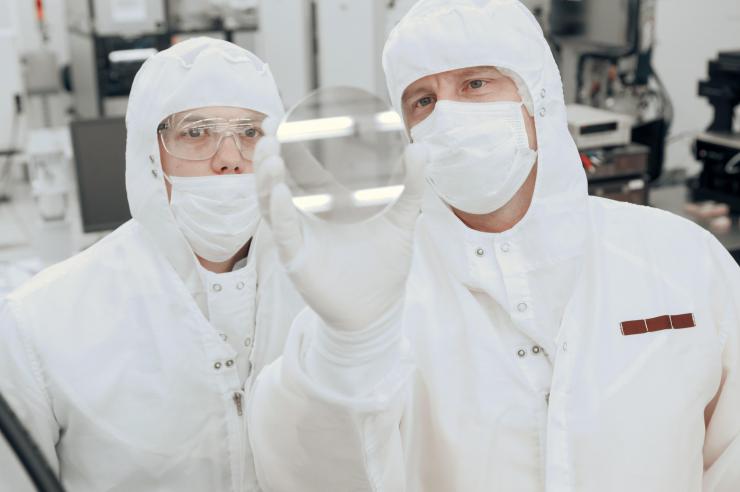 <p>Georgia Tech professor Alan Doolittle and research engineer Brooks Tellekamp hold up an example of nanoscale materials used in advanced computing. Credit: Georgia Tech / Christopher Moore</p>