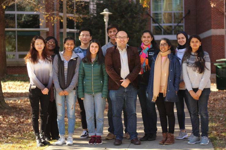 Ahmet Coskun (pictured in center), assistant professor in the Wallace H. Coulter Department of Biomedical Engineering, standing with his laboratory team.