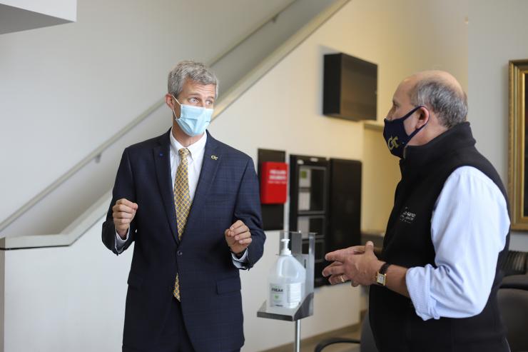 <p>Tim Lieuwen, Regents Professor and David S. Lewis Jr. Chair and executive director of the Strategic Energy Institute, and Paul M. Dabbar engage in discussion before a tour of the Zinn Combustion Laboratory. Photo by Ashley Ritchie</p>