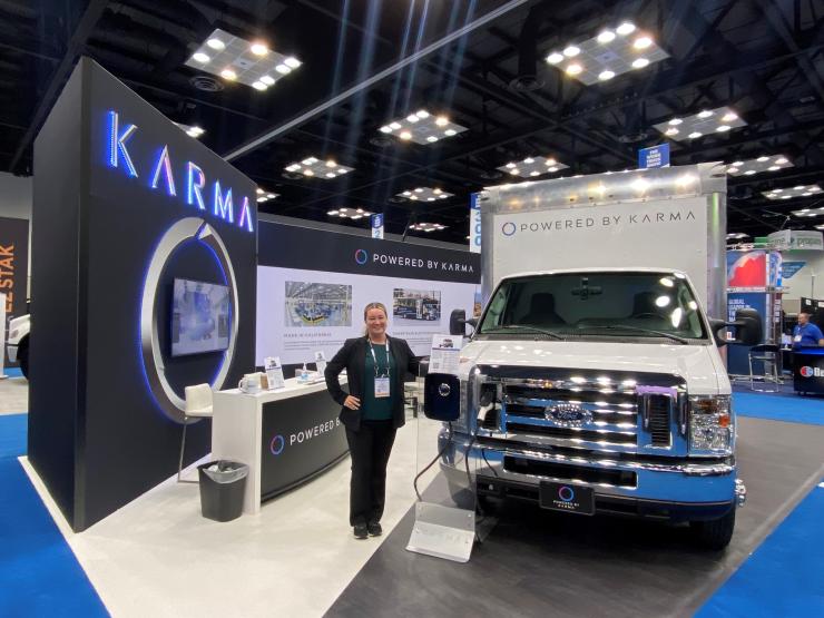 Jenn Voelker showcasing Karma's commercial product line at an auto show. 