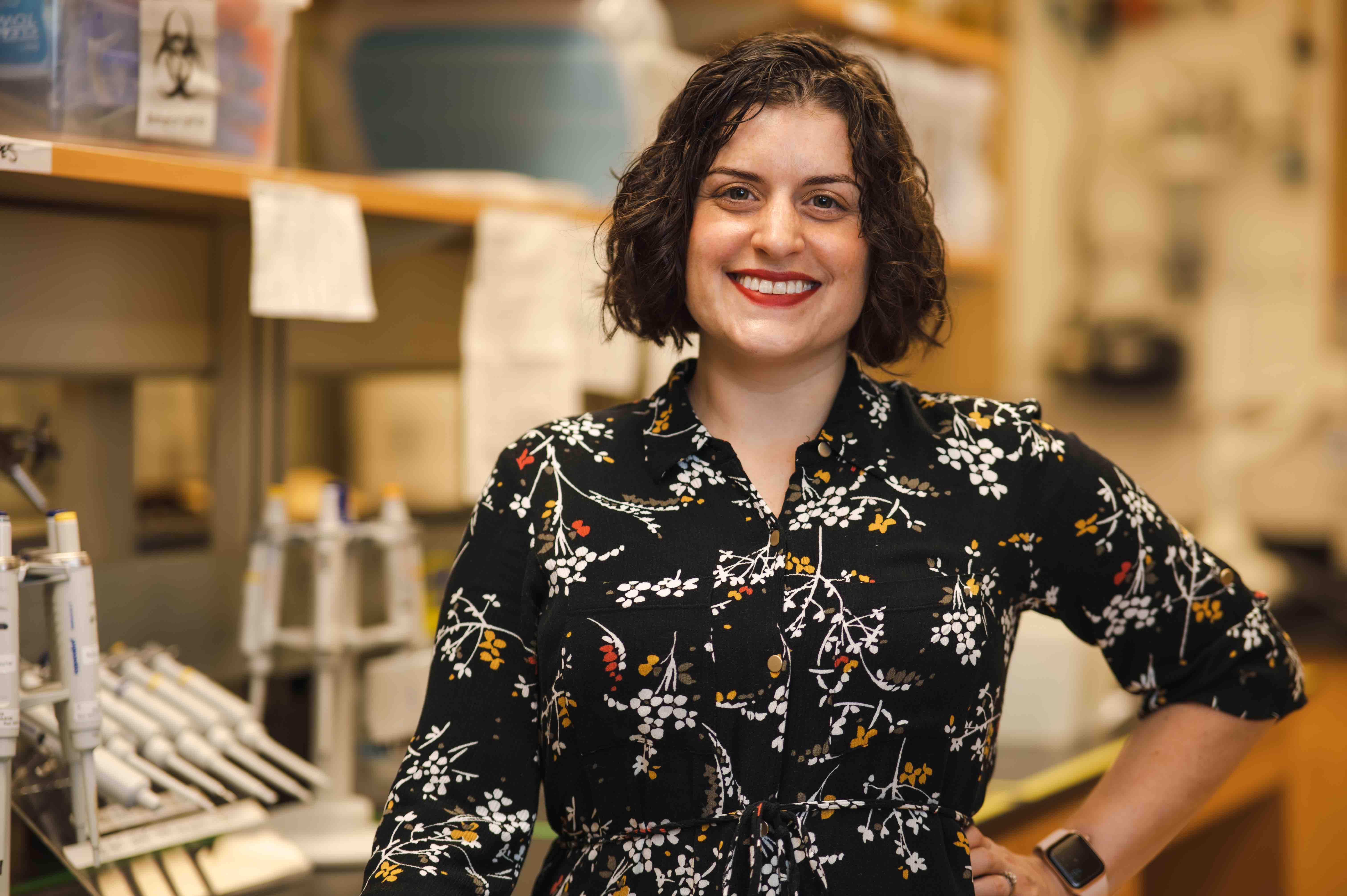 A woman stands in a lab