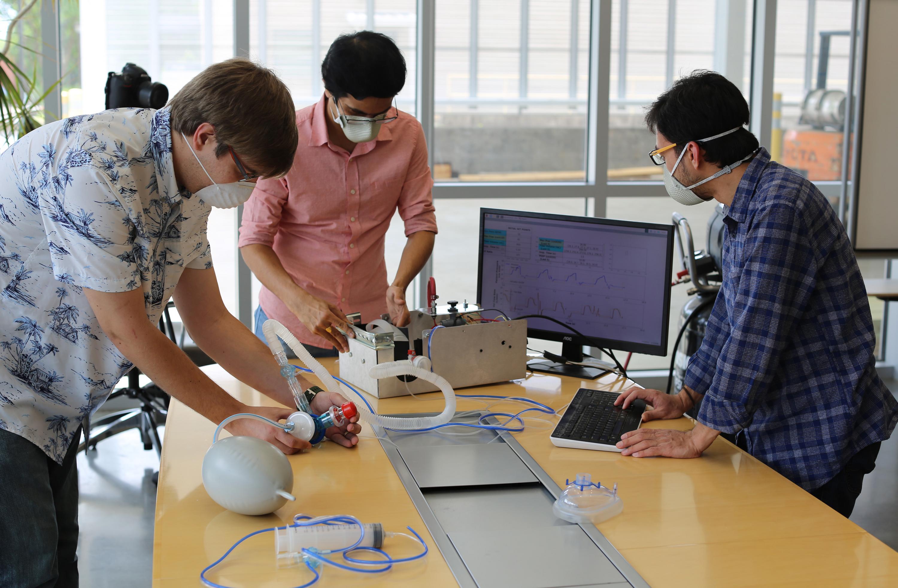 Georgia Tech Researchers Stephen Johnston, Gokul Pathikonda and Prithayan Barua work on their Open-AirVentGT, a low-cost, portable emergency ventilator that uses electronic sensors and computer control to manage key clinical parameters. (Credit: Ben Wright, Georgia Tech)