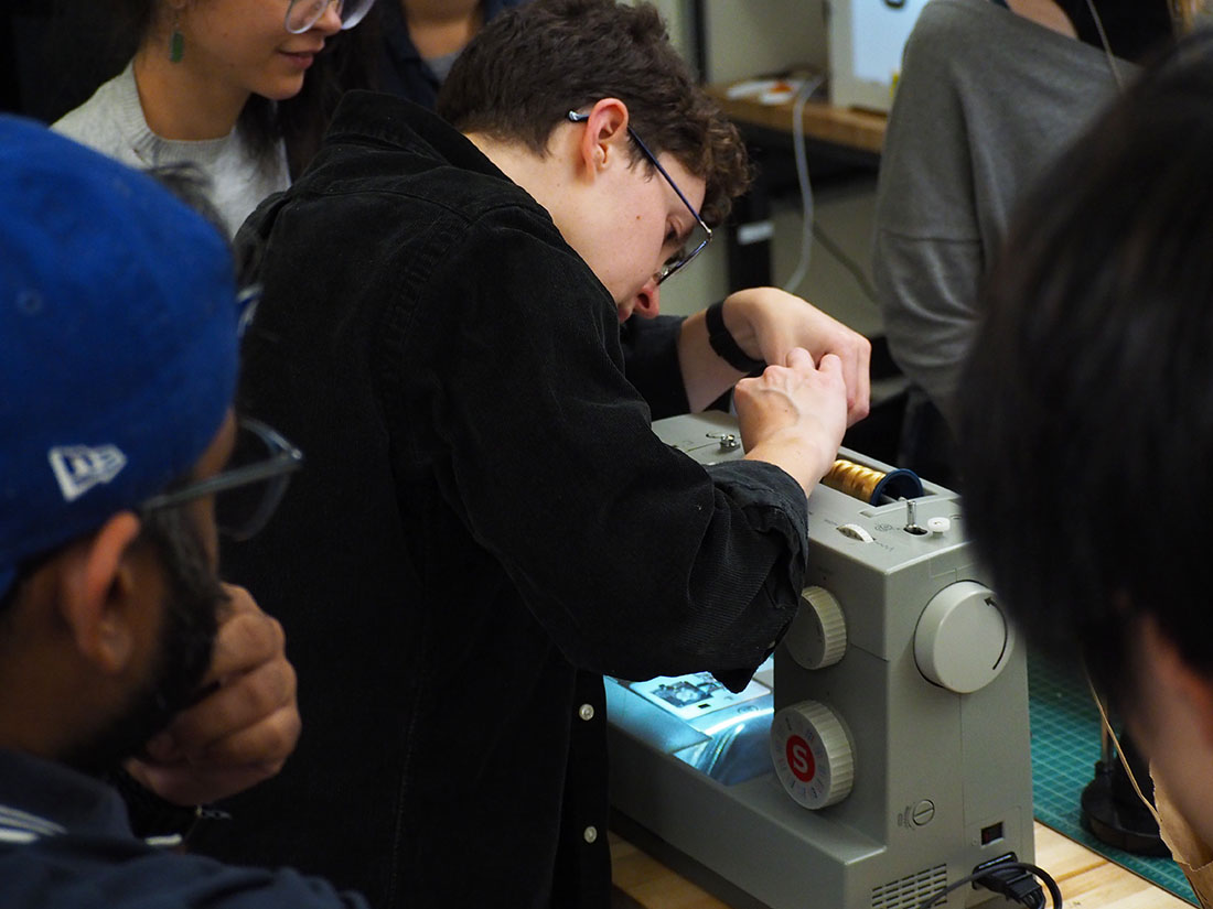  Foley Scholar finalist Allie Riggs (PhD DM) demonstrates the use of an industrial sewing machine.