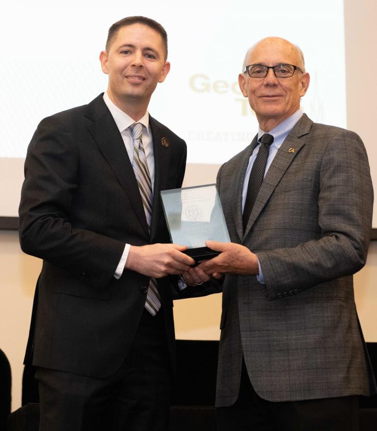 Joe Lachance acceps his award from Carol Subiño Sullivan of the Center for Teaching and Learning at Georgia Tech.