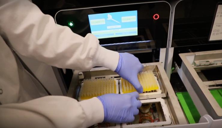 Tip trays are set into the machine to begin a wash cycle.