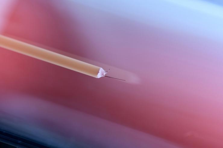 <p>A material being evaluated for use in new DC breakers is assessed in a low-pressure plasma at the Georgia Institute of Technology. A Langmuir probe with a tungsten tip is introduced into the plasma. (Photo: Rob Felt, Georgia Tech)</p>