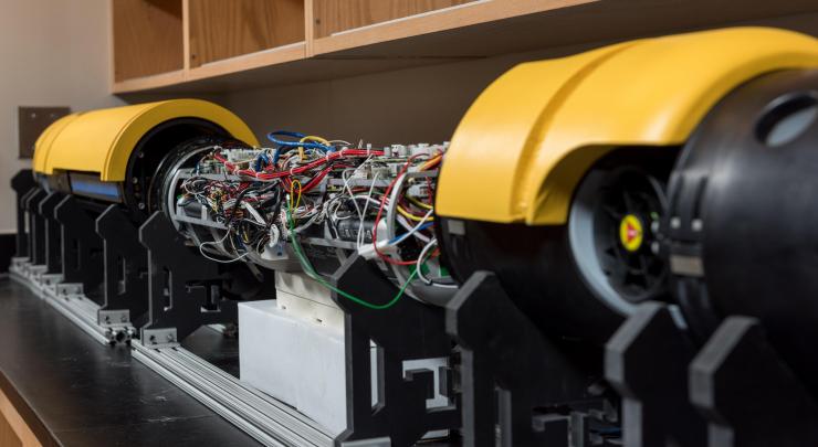 <p>Showing its guts, the robotic submarine Icefin rests on a lab bench at Georgia Tech. Icefin probes for signs of life in waters under ice surfaces. In the future, a highly updated version could ride a rocket to our planetary neighbors in the solar system for deployment in their under-ice oceans. Credit: Georgia Tech</p>