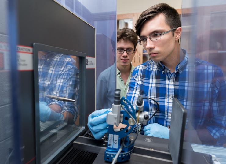 <p>Lead author Joseph Paddison (back) and graduate student Marcus Daum in Martin Mourigal's physics lab at Georgia Tech. Credit: Georgia Tech / Rob Felt</p>