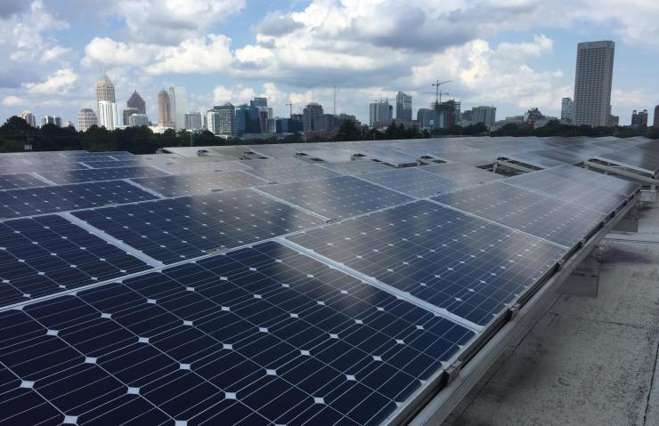 <p>Rows of photovoltaic panels are shown atop a building on the Georgia Institute of Technology campus in Atlanta. (Credit: John Toon)</p>