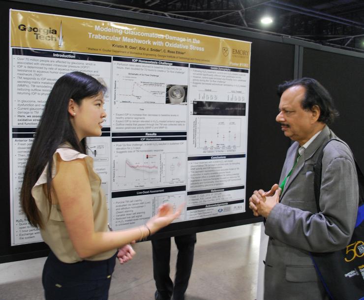 <p>BME student Kristin Gao discusses her research poster with Balakrishna Pai, director of instructional iaboratories for the Coulter Department.</p>