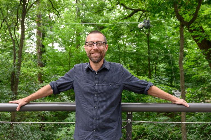 <p>Georgia Tech Professor and School Chair Magnus Egerstedt on the Canopy Walk with the SlothBot behind them. SlothBot is a slow-moving and energy-efficient robot that can linger in the trees to monitor animals, plants, and the environment below. (Credit: Rob Felt, Georgia Tech)</p>