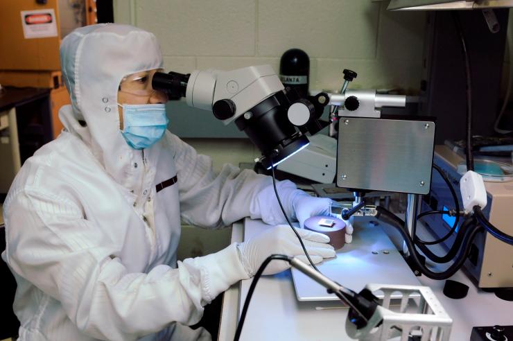 <p>GTRI researcher Hunter Chan is shown wire bonding a photovoltaic cell to package for study on the International Space Station. (Credit: Gary Meek, Georgia Tech).</p>