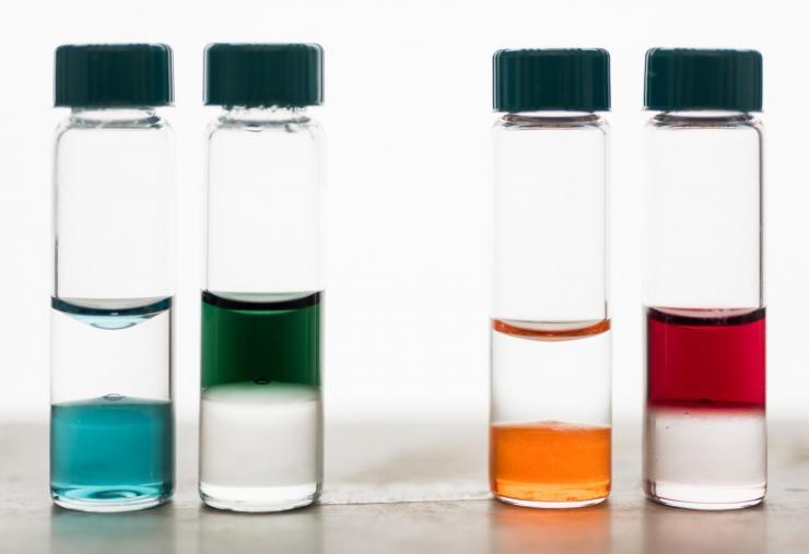 <p>Electronic polymer inks in biphasic solutions of chloroform (bottom) and water (top). Precursor polymers dissolve in organic solvents (like chloroform) but can be transitioned to a water soluble form. Credit: Georgia Tech / Rob Felt</p>