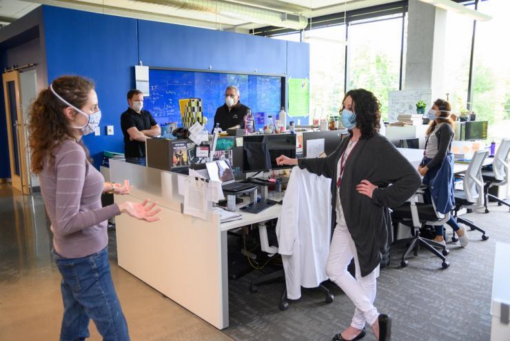 Professor Philip Santangelo (BME) and his Covid-19-focused lab team convene inside the Krone Engineered Biosystems Building.