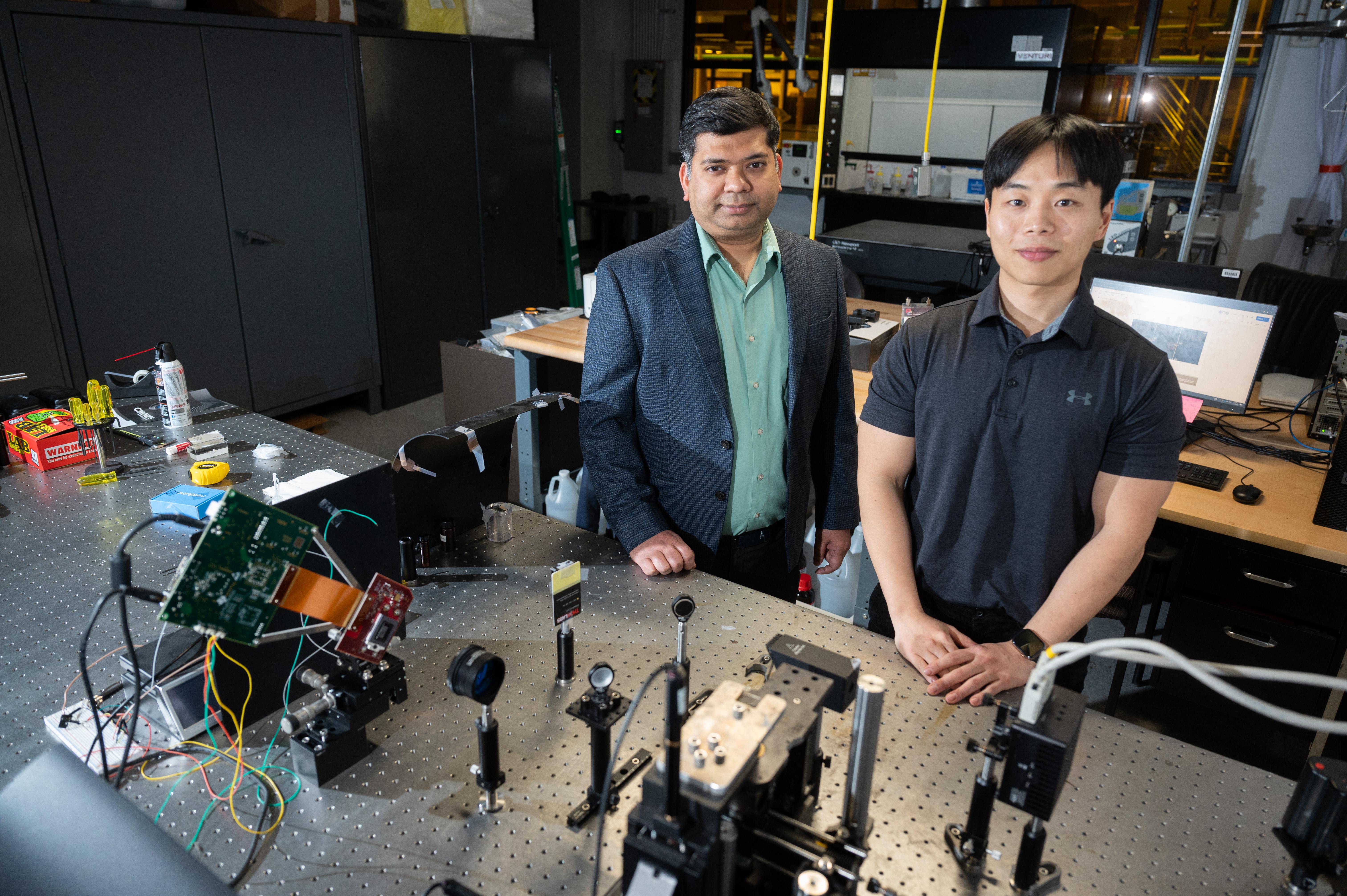 Two men stand in a lab