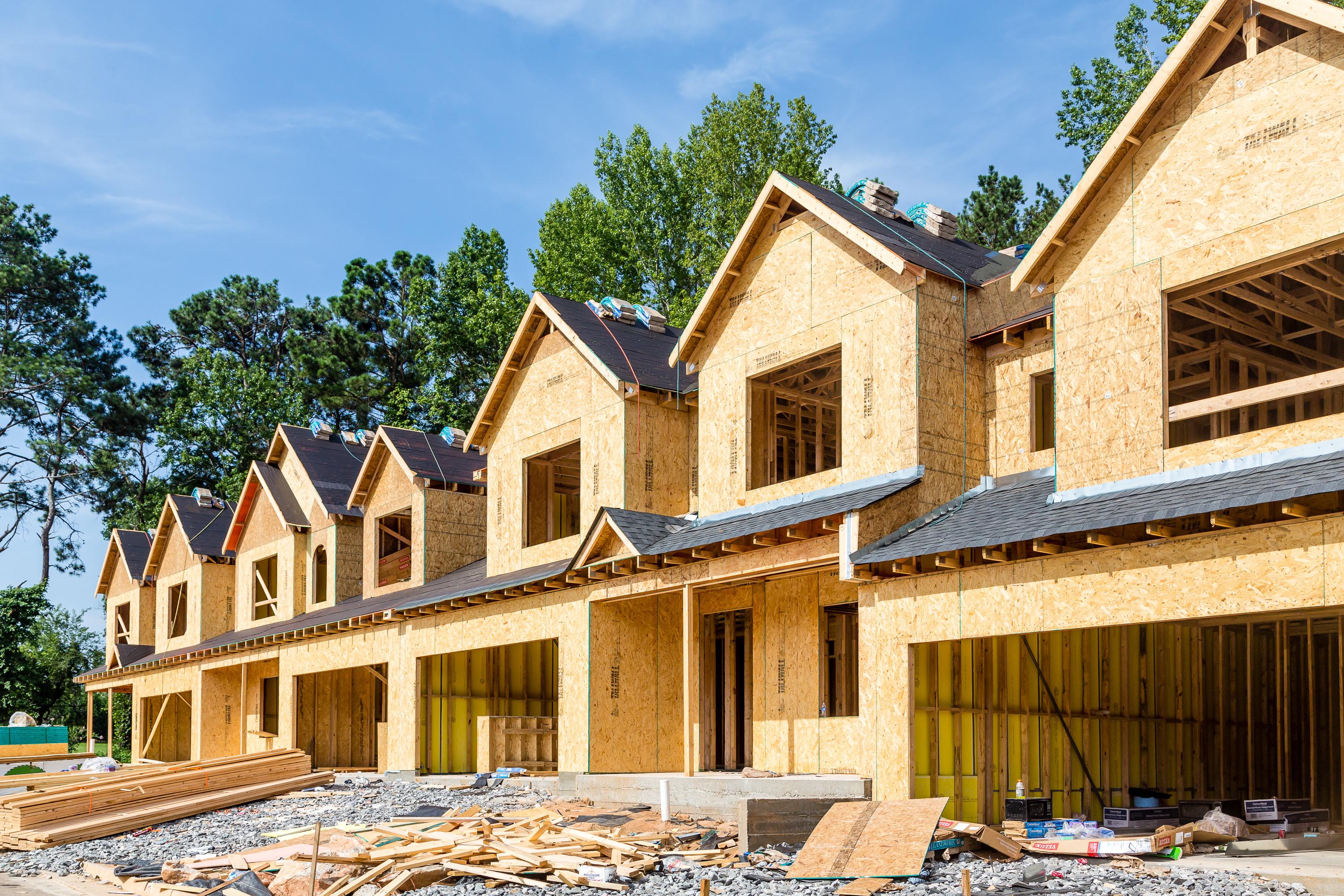 A row of attached homes under construction