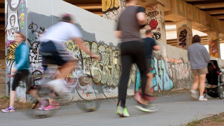 <p>People running, walking and biking along a portion of the Atlanta Beltline</p>