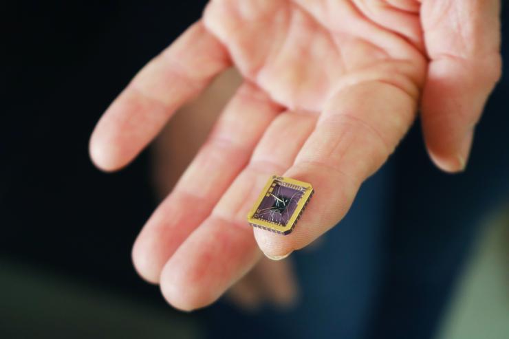 A tiny graphene device on a silicon carbide substrate chip. The device rests on a person's fingertip. Credit: Jess Hunt-Ralston, Georgia Tech 