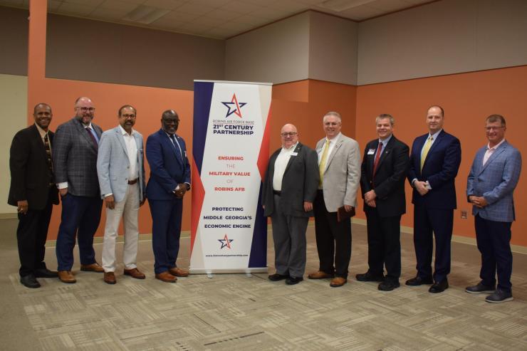 <p>Aaron Stebner, second from left, and Thomas Kurfess, third from right, attending the Robins Regional Chamber’s Eggs and Issues breakfast event on September 8, 2022.</p>