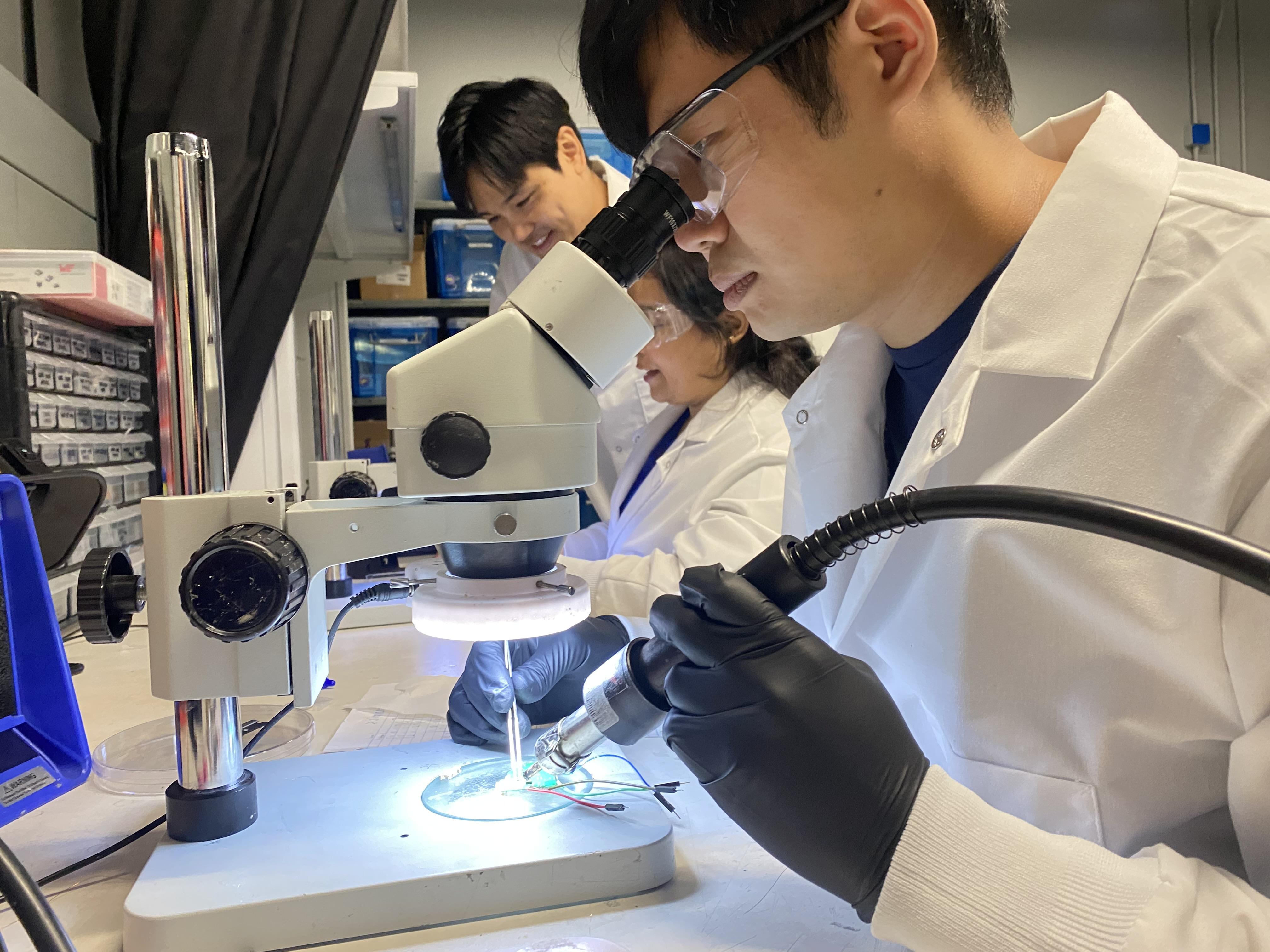 Researchers in Hong Yeo's lab work on the electronics of wearable biosensors