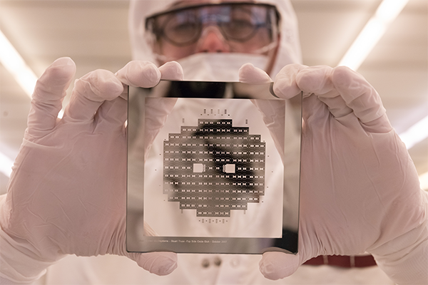 Cleanroom staff holding a wafer