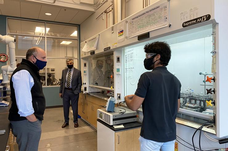 <p>Ph.D. student Aravindh Rajan explains how the world’s first continuous thermoelectrochemical cooler prototype works as Paul M. Dabbar tours the Scalable Thermal Energy Engineering Lab (STEEL). The lab is located within the Carbon Neutral Energy Solutions (CNES) building and is under the direction of Associate Professor Shannon Yee. Photo by Ashley Ritchie</p>