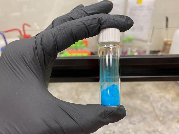 <p>The vial shown contains a blue powder, HKUST-1, a metal-organic framework (MOF) material. (Credit, Tania Evans, Georgia Tech)</p>