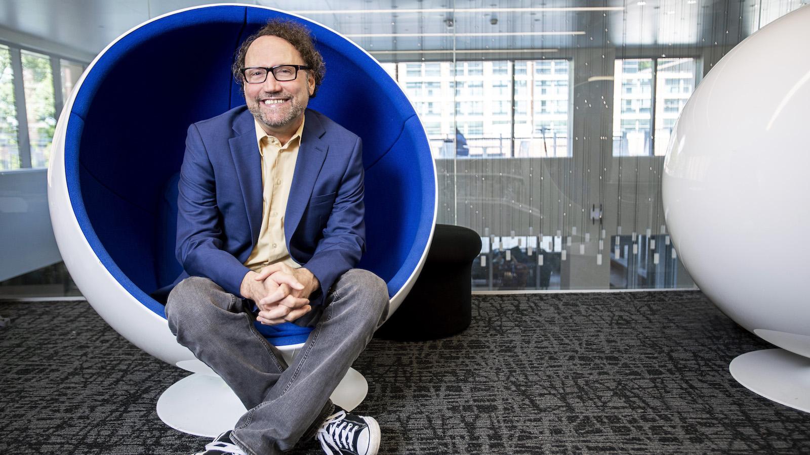 Michael Best, executive director of the Institute for People and Technology, seated in a round chair.