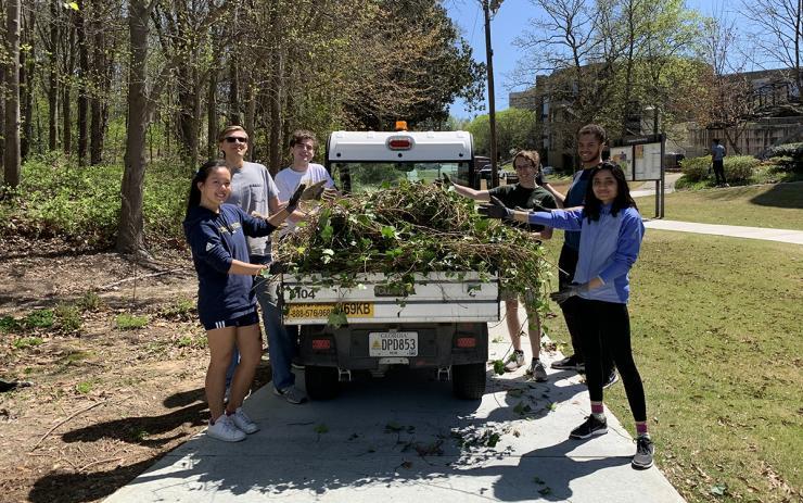 <p>Volunteers from Students Organizing for Sustainability remove ivy from an area near The Kendeda Building for Innovative Sustainable Design in April 2022.</p>