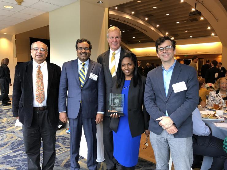 <p>South Big Data Hub recieved the Outstanding Research Award from the Institute and are shown holding the award alongside Georgia Tech President Bud Peterson.</p>