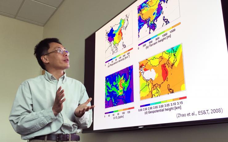 <p>Georgia Tech Professor Yuhang Wang explains maps showing terrain, population density and other issues affecting haze formation in the East China Plains during winter months. (Credit: John Toon, Georgia Tech)</p>