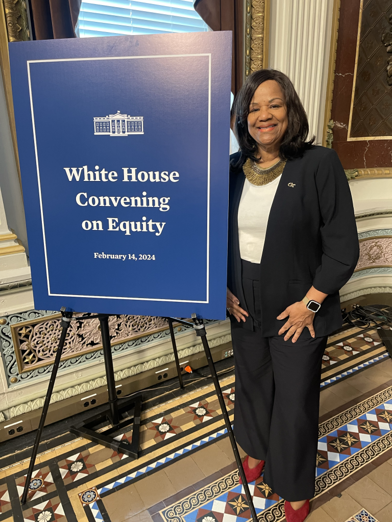 Donna Ennis next to poster board