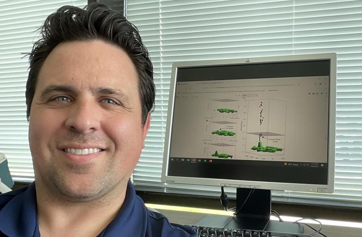 <p>GTRI researcher Levi Boggs is shown with a schematic showing the structure of a gigantic jet.</p>