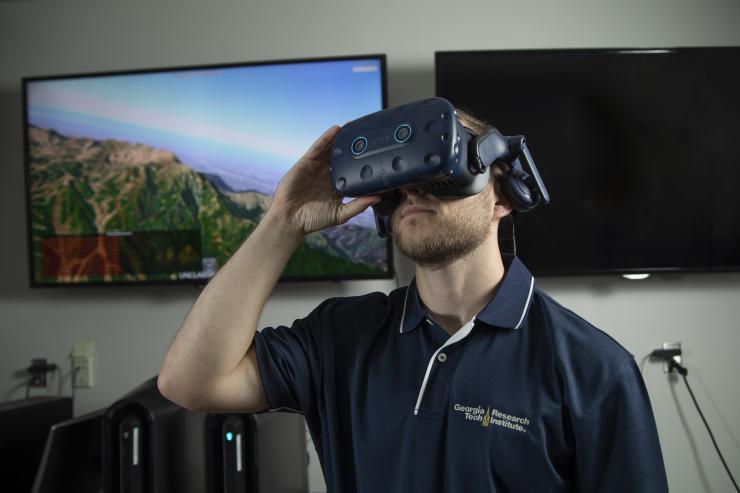 GTRI Research Scientist Dylan Bush demonstrates an F-16 simulation that was used to evaluate the Inter-rater Reliability of the scale of the simulation fidelity scale. (Credit: Christopher Moore)