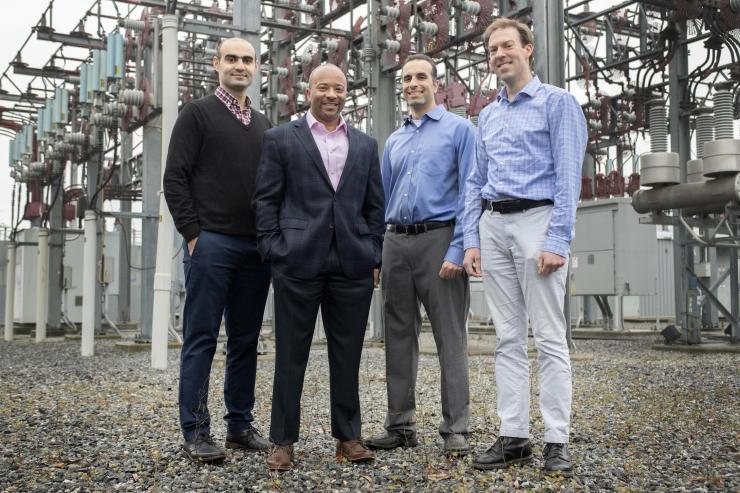 <p>Georgia Tech researchers Tohid Shekari, Raheem Beyah, Morris Cohen, and Lukas Graber are shown with a substation that is part of the electric grid. The researchers have developed a new technique to secure the substations. (Image: Christopher Moore, Georgia Tech)</p>