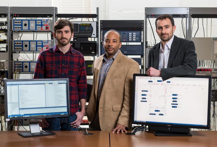 <p>Researchers at the Georgia Institute of Technology are “fingerprinting” devices on the electric grid to improve security. Shown with grid devices and a schematic are (L-R) graduate student David Formby, Associate Professor Raheem Beyah and Assistant Professor Jonathan Rogers. (Credit: Rob Felt, Georgia Tech)</p>