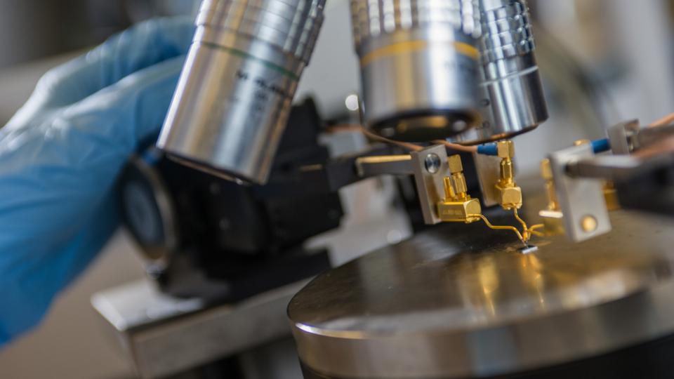 Device being inspected under a microscope