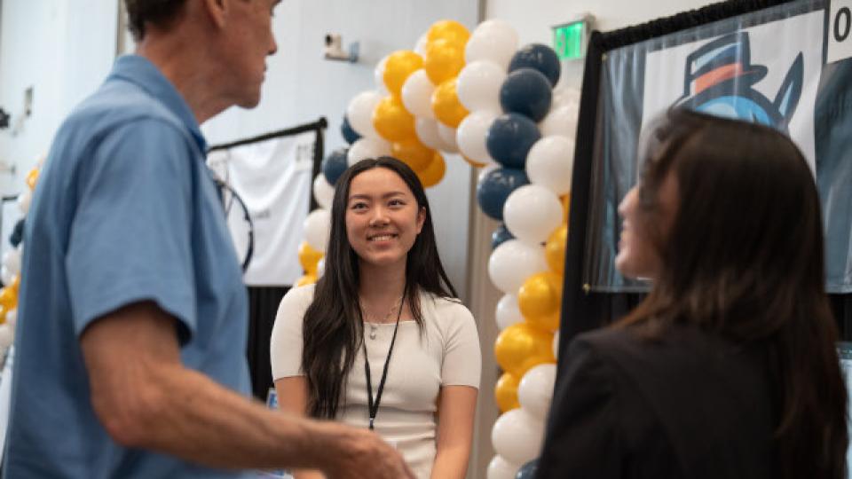 Three individuals discussing a presentation