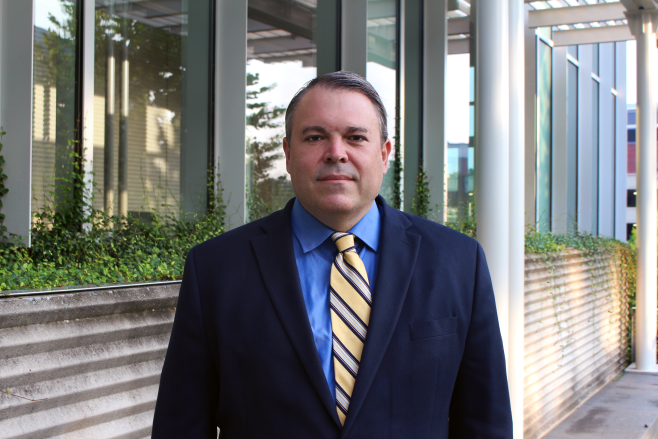 Eric Vogel posing outside of a building on the Georgia Tech campus.